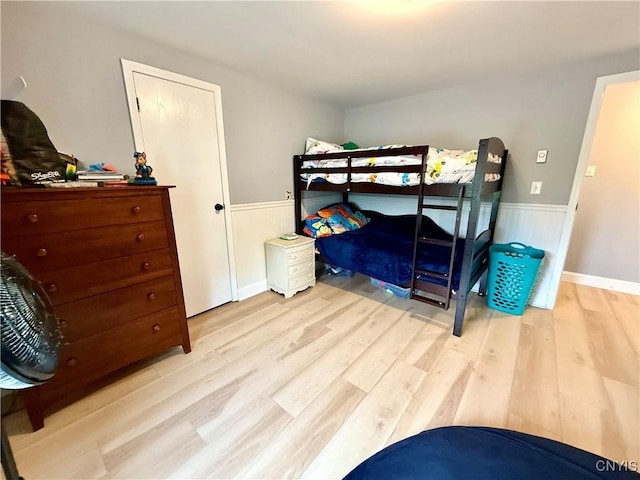 28053 Boat Launch Rd, Lyme, NY 13622 - bedroom featuring a wainscoted wall and wood finished floors