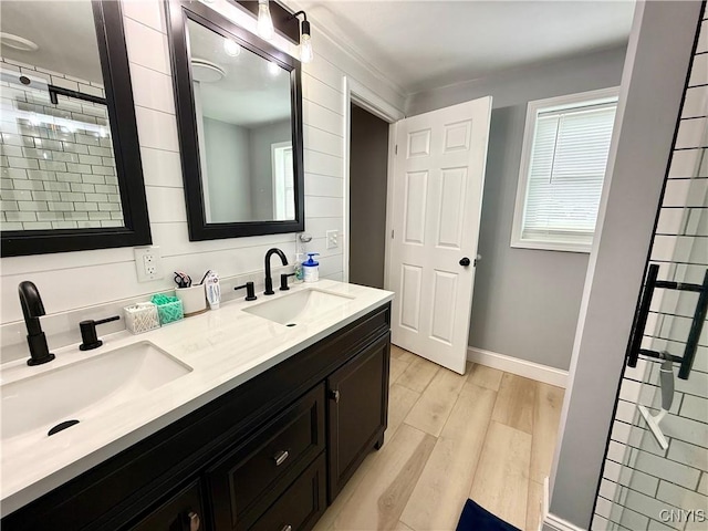 28053 Boat Launch Rd, Lyme, NY 13622 - bathroom featuring double vanity, a sink, wood finished floors, and a healthy amount of sunlight