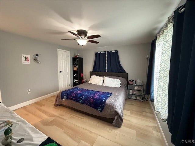 28053 Boat Launch Rd, Lyme, NY 13622 - bedroom with a ceiling fan, baseboards, and light wood-style flooring
