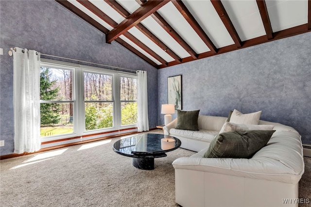 carpeted living area with high vaulted ceiling and beamed ceiling