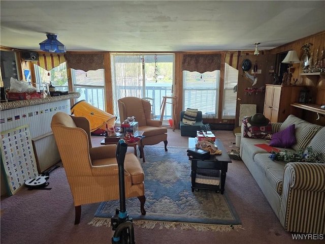 carpeted living room featuring wood walls