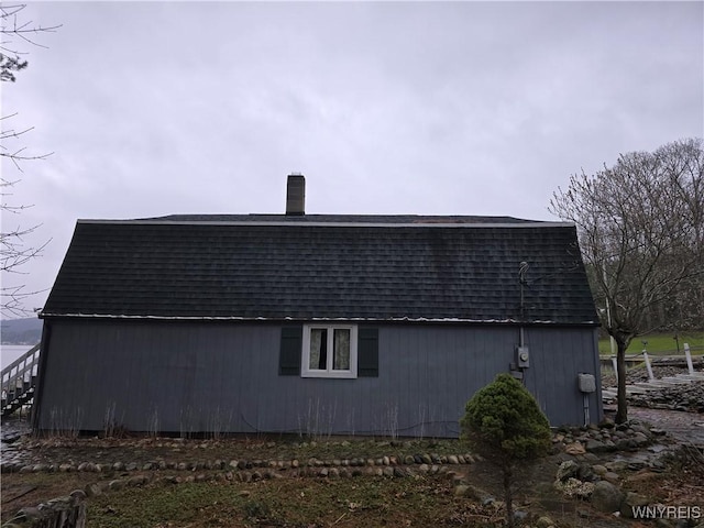 view of property exterior featuring a shingled roof