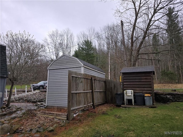 view of shed featuring fence
