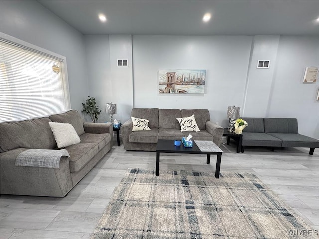 living area featuring light wood finished floors, recessed lighting, and visible vents