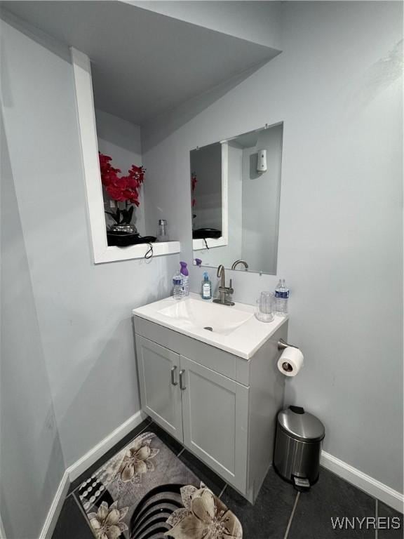 bathroom with vanity and baseboards