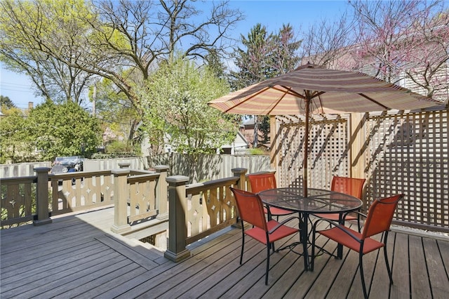 wooden terrace with fence and outdoor dining space
