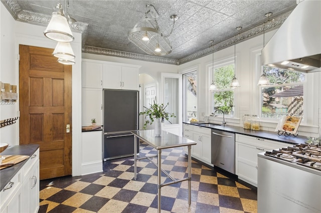 kitchen with dark floors, extractor fan, a sink, and dishwasher
