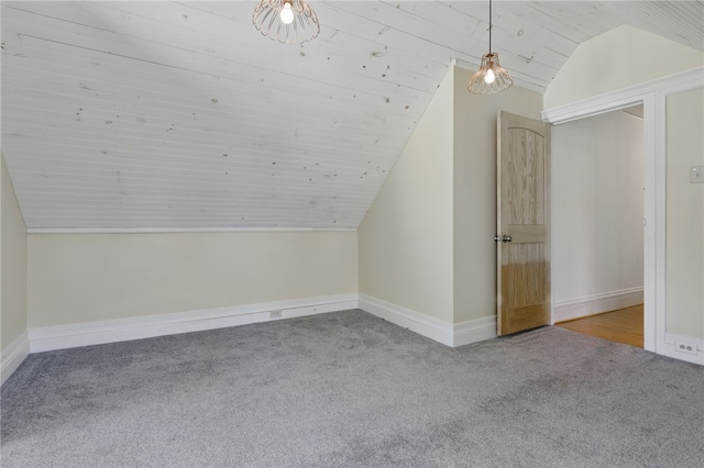 additional living space with baseboards, carpet flooring, wood ceiling, and vaulted ceiling
