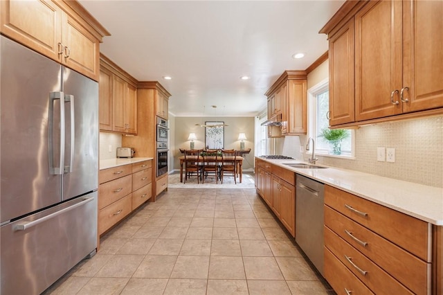 kitchen featuring a sink, light countertops, stainless steel appliances, recessed lighting, and tasteful backsplash