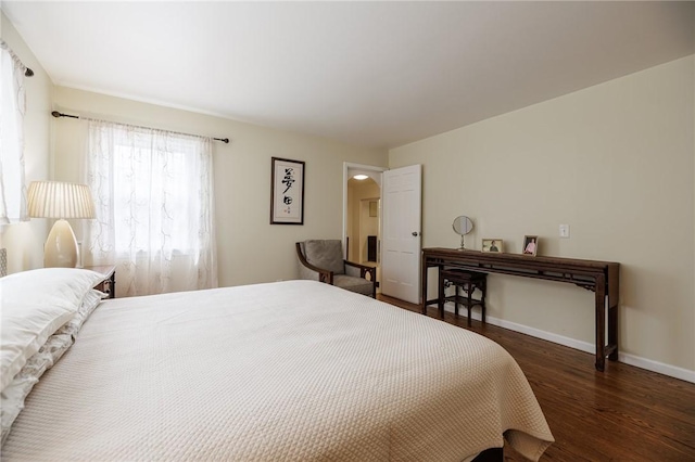 bedroom featuring baseboards and wood finished floors