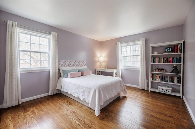 bedroom featuring baseboards and wood finished floors