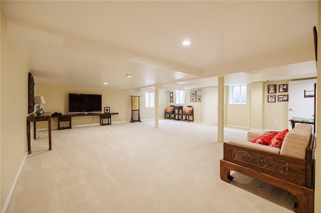 living area featuring baseboards, recessed lighting, and light colored carpet