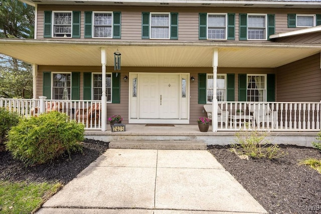entrance to property featuring a porch