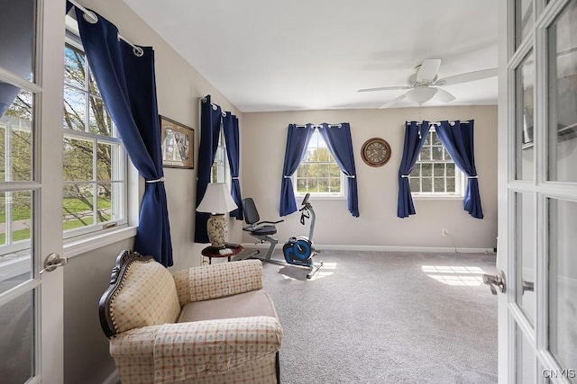 sitting room with baseboards, carpet flooring, and ceiling fan