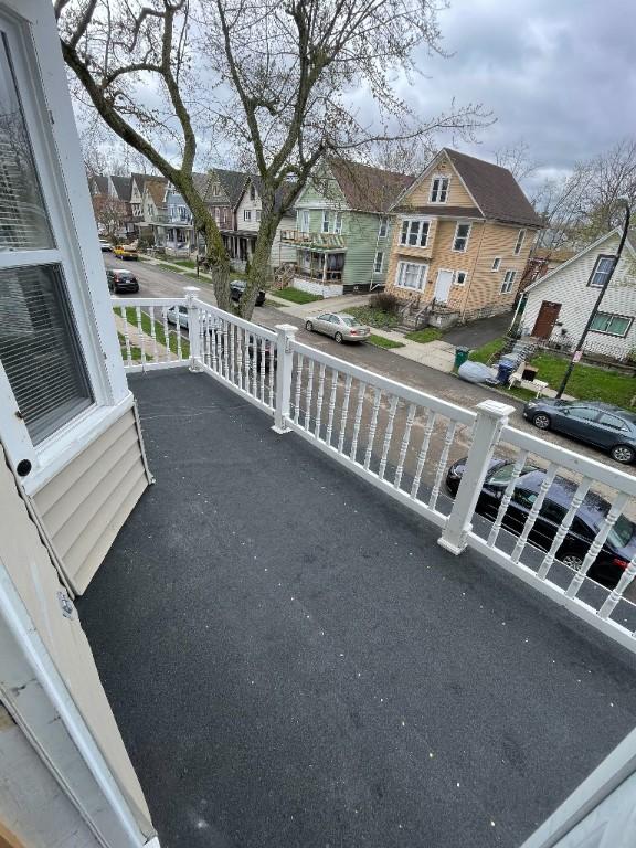 balcony with covered porch and a residential view