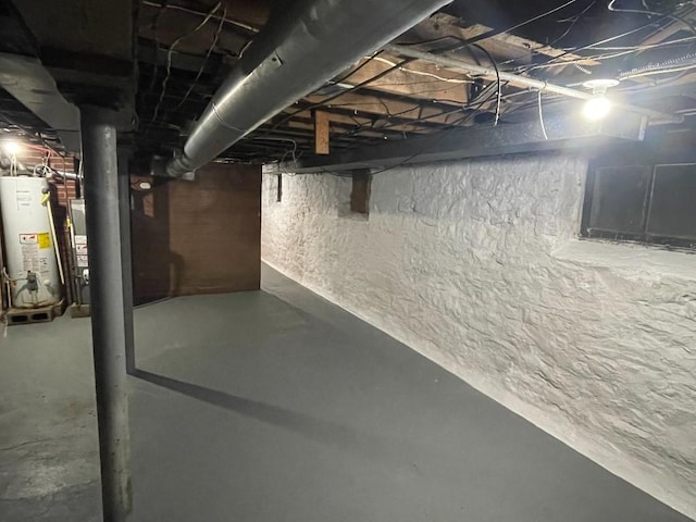 unfinished basement featuring water heater and heating unit