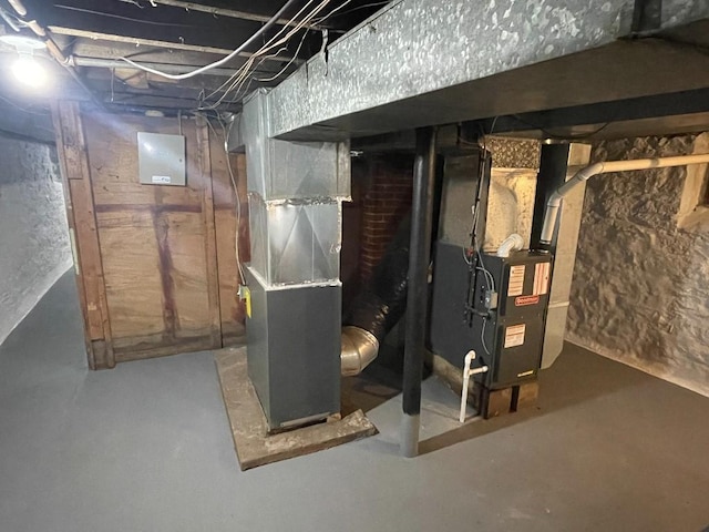 unfinished basement featuring heating unit