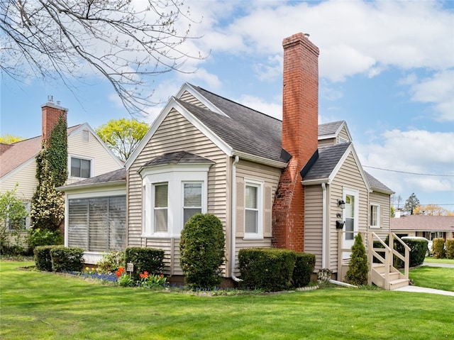 view of property exterior with a lawn, a chimney, and a shingled roof