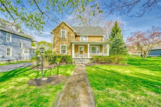 traditional home with a front lawn and covered porch