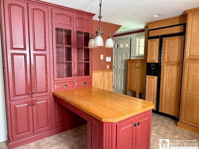148 Myrtle St, Jamestown, NY 14701 - kitchen featuring paneled built in fridge, reddish brown cabinets, and decorative light fixtures