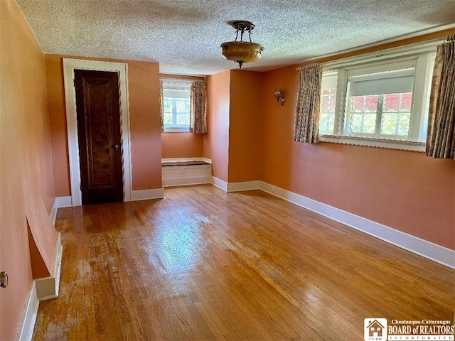 148 Myrtle St, Jamestown, NY 14701 - spare room featuring baseboards, a textured ceiling, and wood finished floors