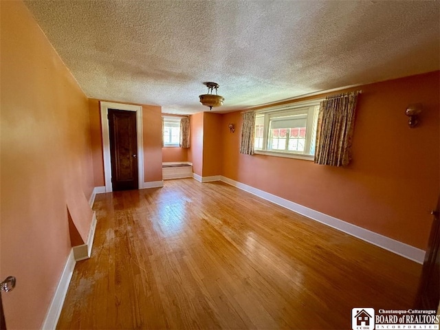 148 Myrtle St, Jamestown, NY 14701 - spare room featuring baseboards, a textured ceiling, and wood finished floors