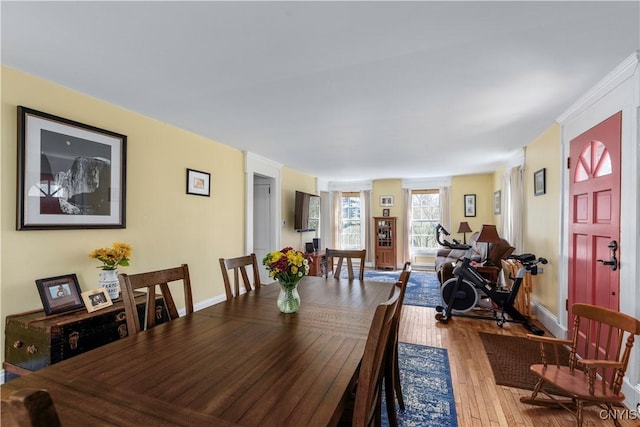 dining room with baseboards and wood finished floors