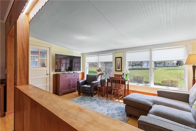 living room with light wood-style flooring and lofted ceiling