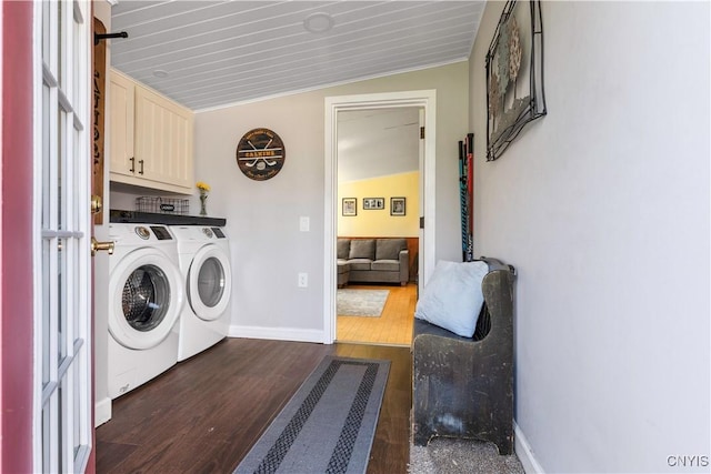 clothes washing area featuring baseboards, cabinet space, independent washer and dryer, and dark wood finished floors