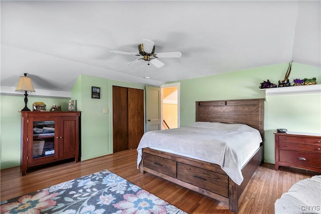 bedroom featuring ceiling fan, vaulted ceiling, and wood finished floors