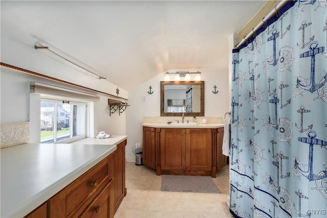 bathroom with vanity, a shower with curtain, and lofted ceiling