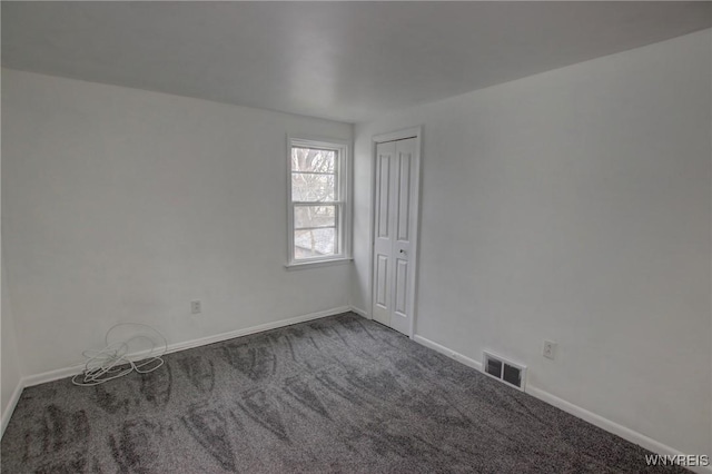 unfurnished room featuring visible vents, carpet flooring, and baseboards