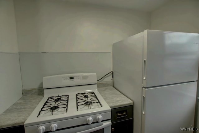 kitchen featuring white appliances and light countertops