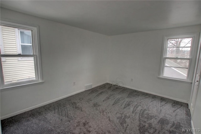 carpeted empty room with baseboards and visible vents