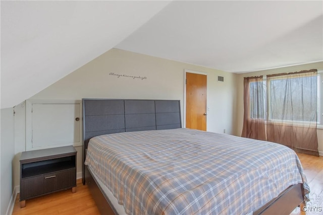 bedroom featuring visible vents and light wood-style flooring