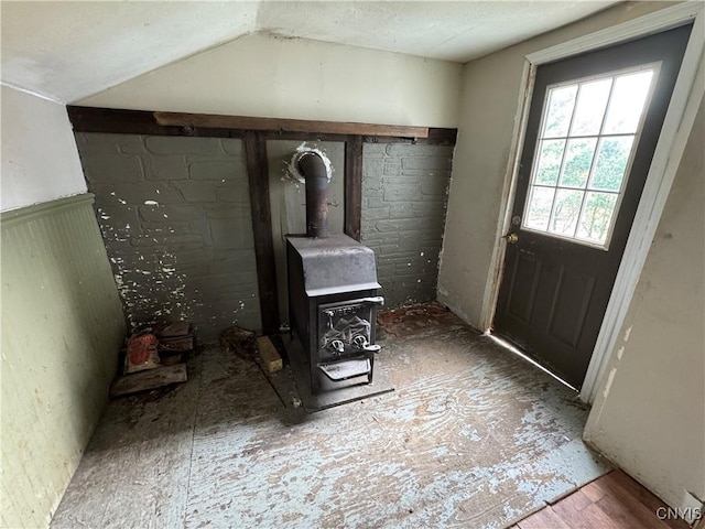 interior space featuring a wood stove and a textured ceiling