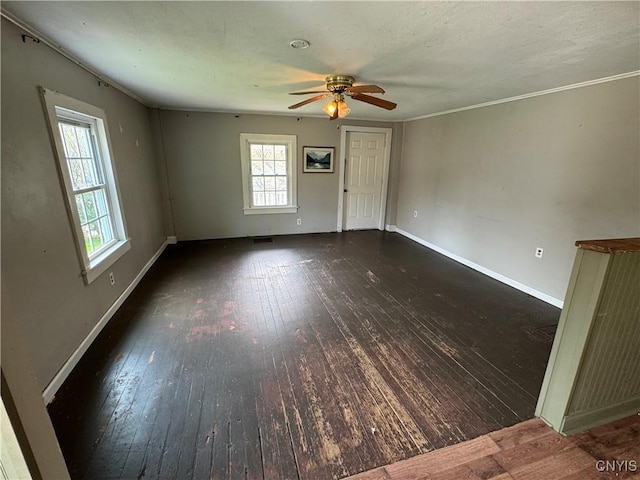 spare room with baseboards, ceiling fan, and wood-type flooring