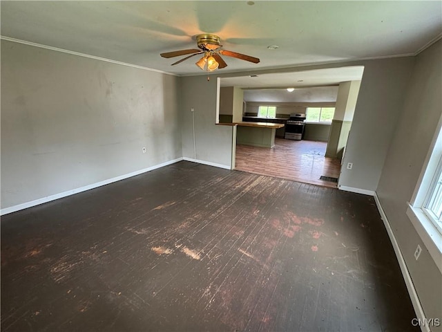 unfurnished living room featuring wood-type flooring, a ceiling fan, baseboards, and crown molding