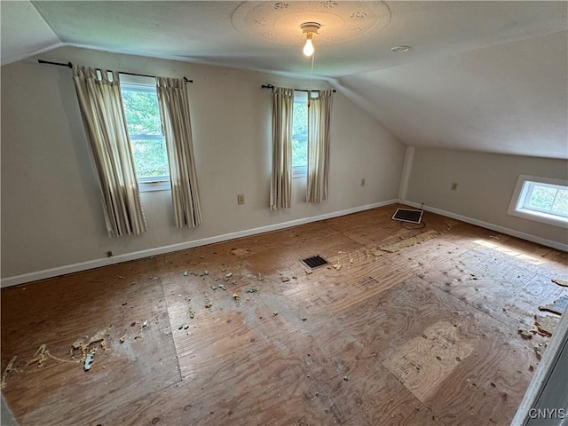 bonus room featuring baseboards, vaulted ceiling, and visible vents
