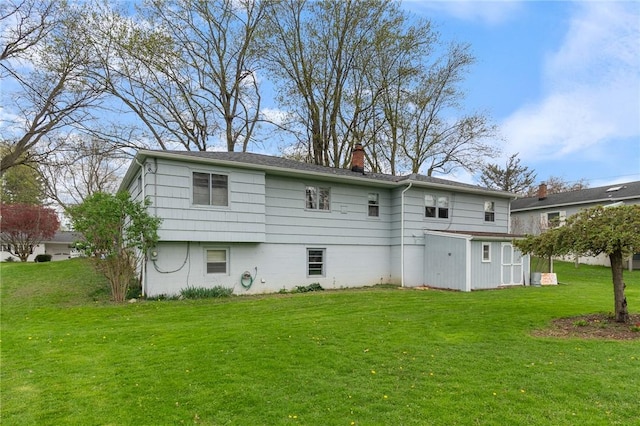 back of house featuring a yard and a chimney
