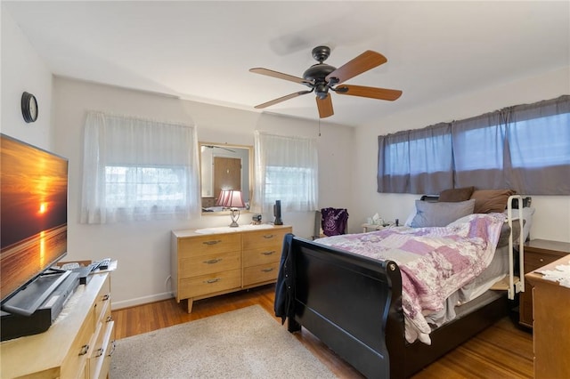 bedroom featuring a ceiling fan and wood finished floors