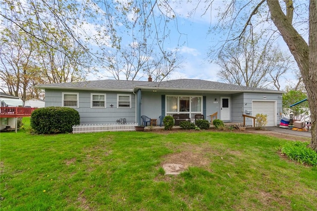 ranch-style house with a garage, fence, driveway, and a front yard