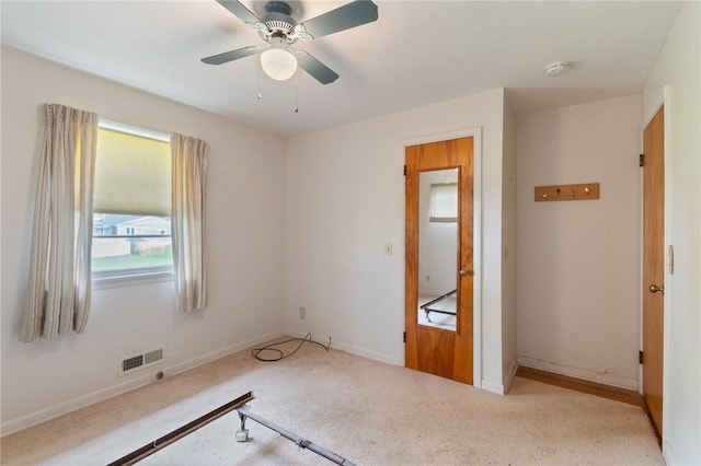 unfurnished bedroom with visible vents, carpet flooring, baseboards, and ceiling fan