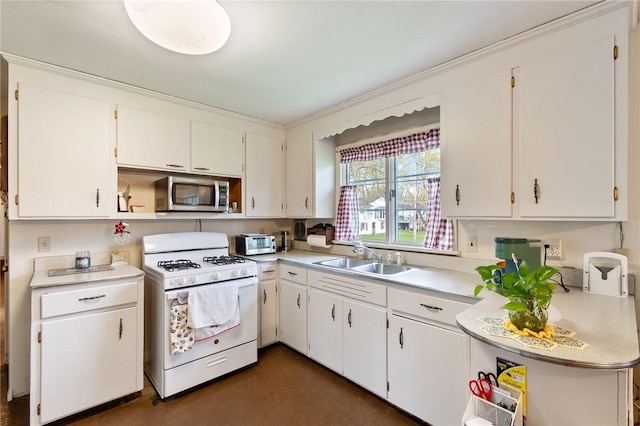 kitchen featuring white cabinets, a sink, light countertops, gas range gas stove, and stainless steel microwave