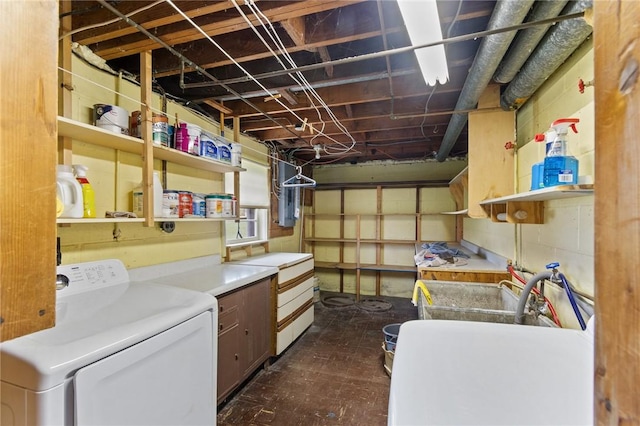 clothes washing area featuring electric panel, cabinet space, and washing machine and clothes dryer