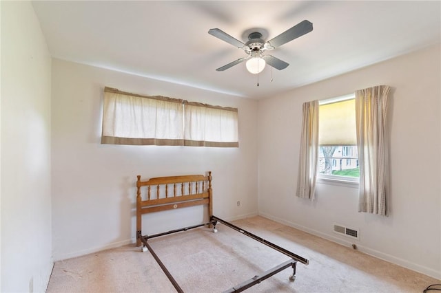 bedroom featuring carpet flooring, a ceiling fan, baseboards, and visible vents