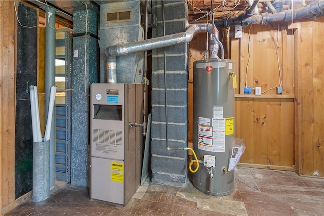 utility room with gas water heater and visible vents
