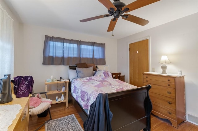 bedroom featuring ceiling fan, light wood-style flooring, and visible vents
