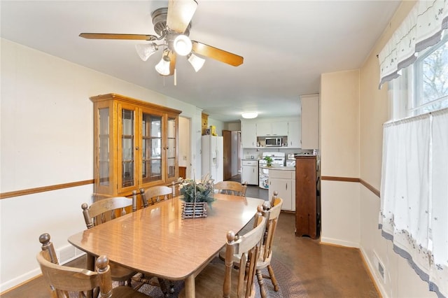 dining space with baseboards, visible vents, and ceiling fan