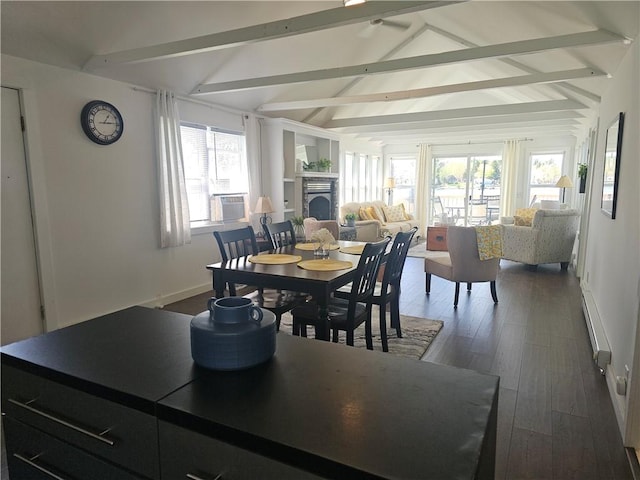 dining room featuring a fireplace, baseboard heating, baseboards, lofted ceiling with beams, and dark wood-type flooring